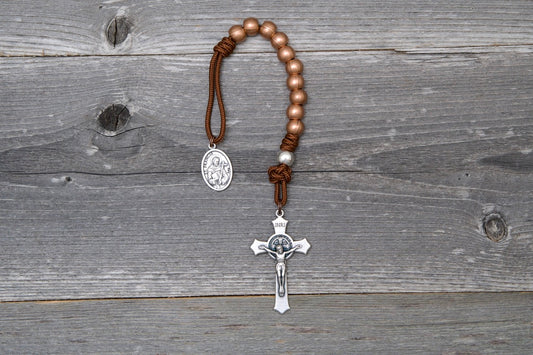 St. Francis metal rosary with copper beads, brown paracord, a silver St. Benedict crucifix, and medal.