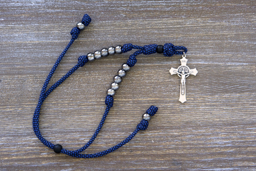 Blue and Gunmetal Rearview Mirror Paracord Rosary for Catholic prayer on-the-go, featuring ten gunmetal Hail Mary beads, matte black Our Father bead, silver St. Benedict crucifix.