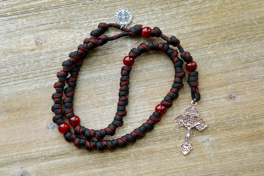 The Blood of Christ - Red and Black Knotted Rope Rosary | Unleash the power of prayer with this durable, premium paracord rosary designed by Sanctus Servo. This handmade Catholic gift features bold red Our Father beads and intricately knotted Hail Mary beads, symbolizing Christ's passion.