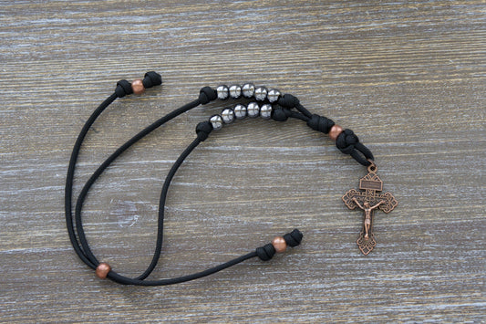 Ancient Armor Rearview Mirror Rosary with Black Paracord, Antique Copper Beads and Gunmetal Hail Mary beads. Perfect Accessory for Your Vehicle's Rearview Mirror to Inspire Faith and Strength in Life's Battles.