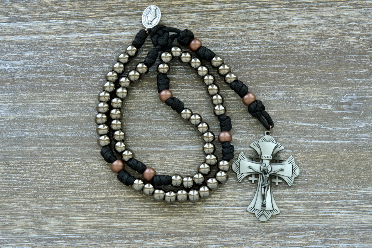 Ancient Armor - 5 Decade Paracord Rosary: Unbreakable, premium quality rosary for Catholic warriors. Featuring large gunmetal Hail Mary beads, antique copper Our Father beads, black paracord, a grey Jerusalem cross, and Miraculous Medal devotional medal.