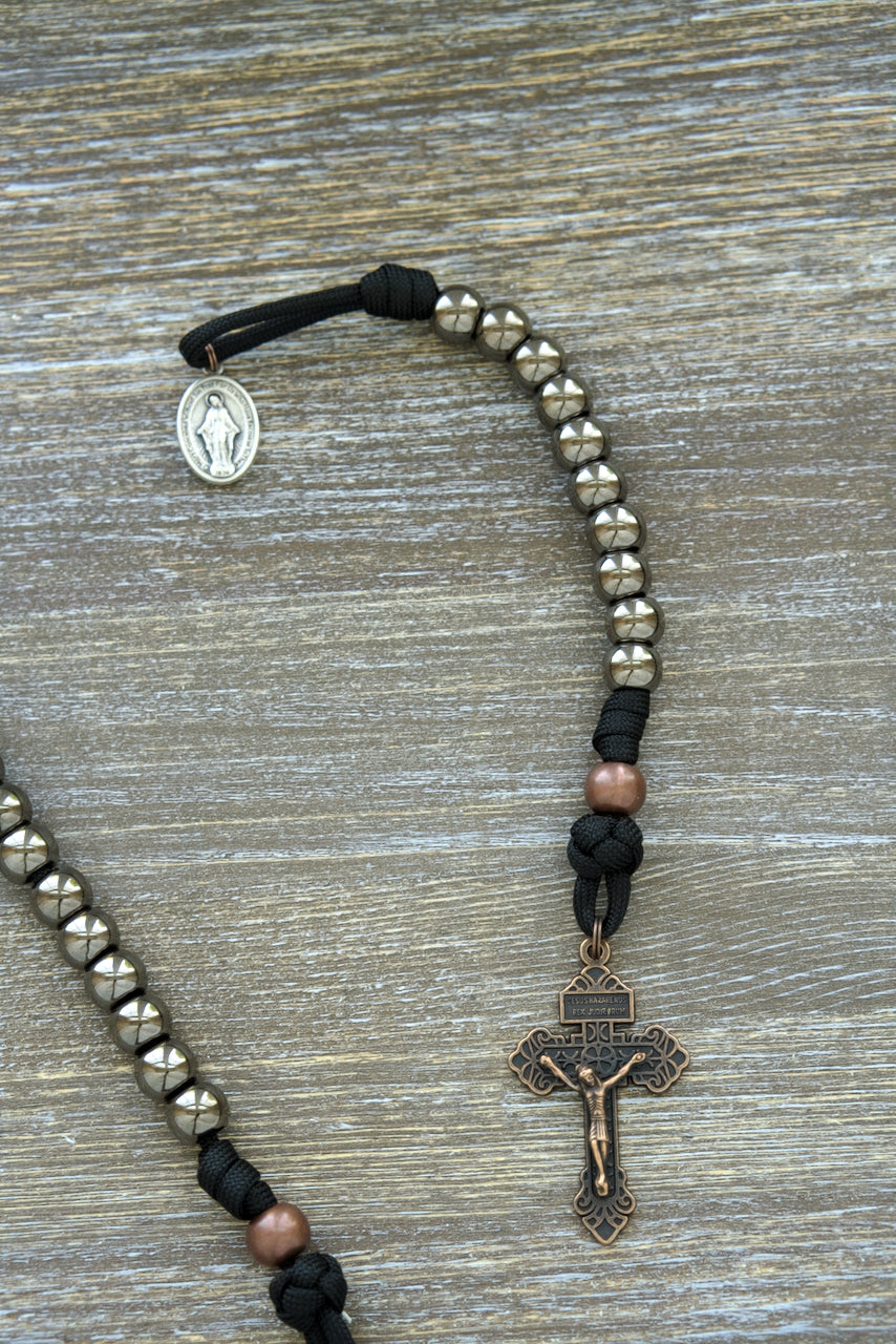 Ancient Armor - Pocket Paracord Rosary: Premium, unbreakable paracord rosary with large gunmetal Hail Mary beads, antique copper Our Father beads, and a copper pardon crucifix. Perfect for Catholic warriors to carry as a spiritual weapon in their fight against evil.