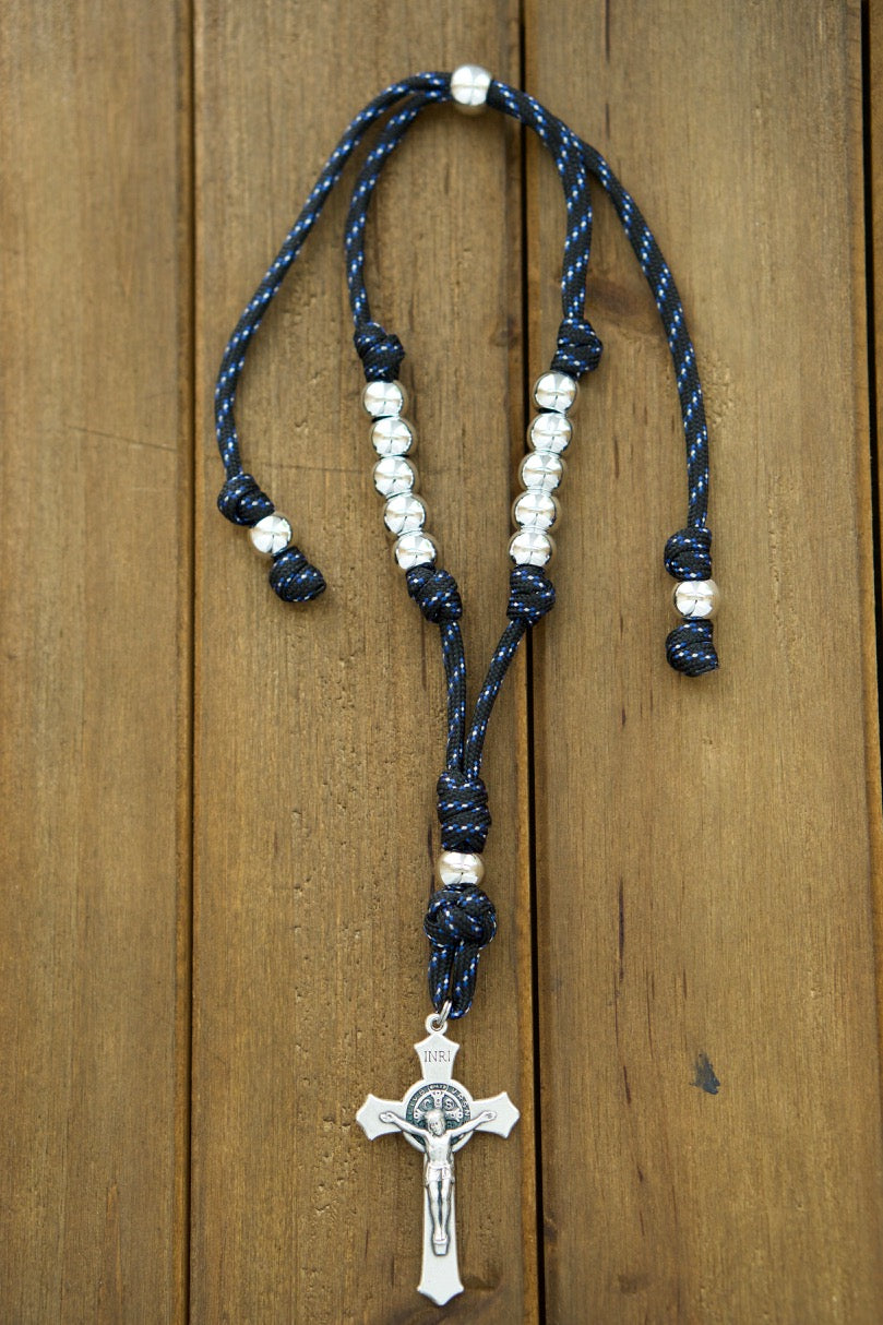 Black, Blue and Silver Rearview Mirror Paracord Rosary - A durable and stylish spiritual weapon for Catholic drivers. Handmade by a small Catholic family, featuring a 2" St. Benedict Crucifix and acrylic accent beads.