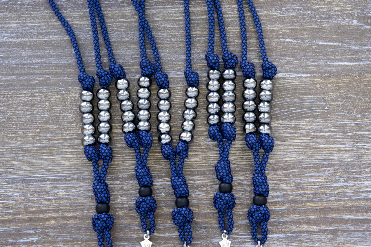 Blue & Gunmetal Rearview Mirror Paracord Rosary for daily prayer on-the-go, featuring gunmetal and matte black beads with a silver St. Benedict crucifix, handmade by Sanctus Servo for Catholics of all ages.