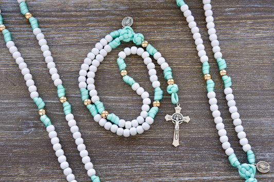 Mint green and white paracord rosary designed for children, featuring durable 10mm acrylic beads, a smaller Miraculous Medal, and a 2-inch St. Benedict crucifix.