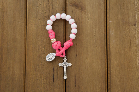 Kids' pink and white pocket paracord rosary, perfect for First Communion or Easter gifts, featuring durable paracord 550, smaller 10mm beads, and easy-to-follow rose gold Our Father beads.
