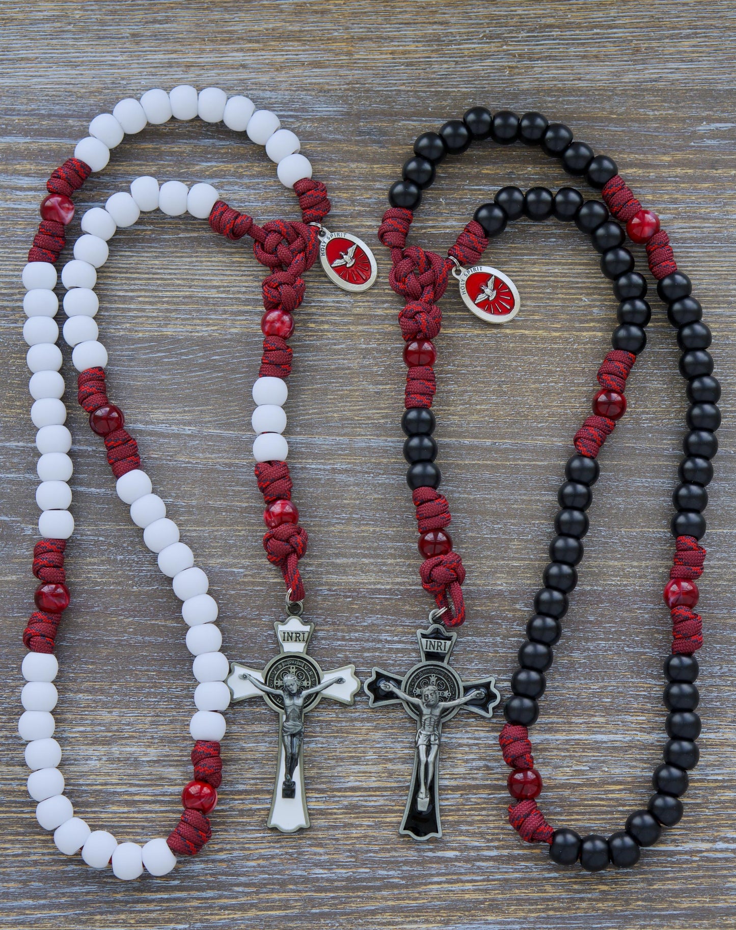 Handcrafted Confirmation paracord rosary with black or white Hail Mary beads, featuring a gleaming black (or white) enamel St. Benedict crucifix and a vibrant red Holy Spirit devotional medal.