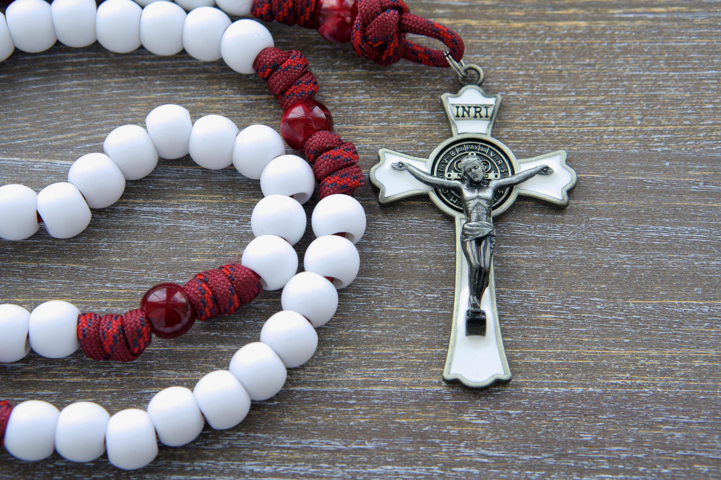 Confirmation gift: A handmade maroon red paracord rosary, The Crimson Shield, showcasing black (or white) Hail Mary beads, a gleaming black (or white) enamel St. Benedict crucifix, and a vibrant red Holy Spirit medal.