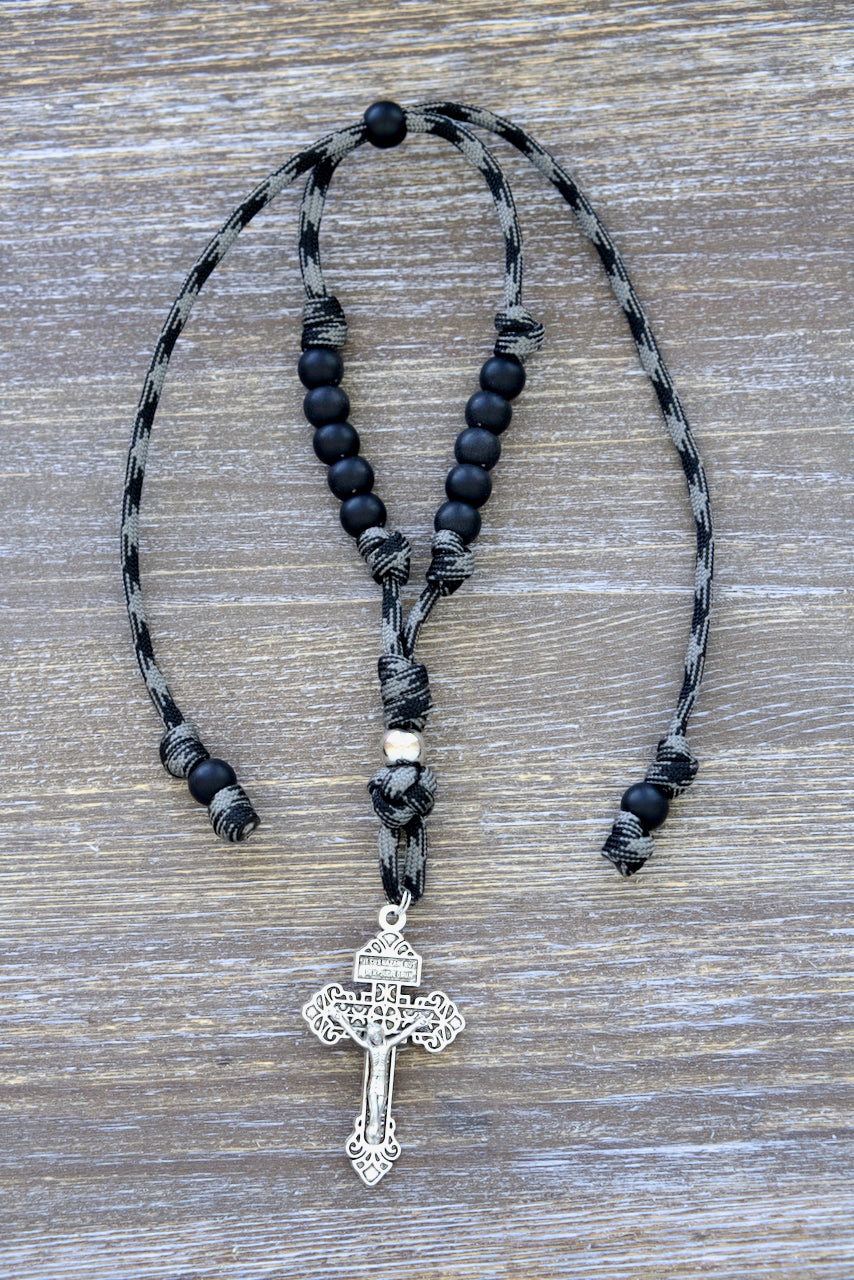 Catholic rearview mirror paracord rosary, "The Demon Destroyer" - 9-inch (expandable to 13 inches) with black and grey pattern, featuring 10 matte black Hail Mary beads, a silver Pardon crucifix, and a silver Our Father bead.