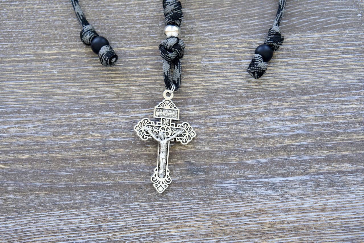 The Demon Destroyer - Rearview Mirror Rosary, a compact and durable paracord rosary designed for on-the-go prayers, featuring ten matte black Hail Mary beads, a silver Pardon crucifix, and one silver Our Father bead.