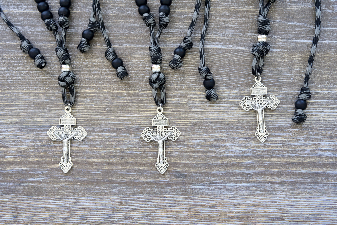 The Demon Destroyer - Rearview Mirror Rosary: Durable 9-inch (expandable to 13 inches) paracord rosary with ten matte black Hail Mary beads, a silver Pardon crucifix, and one silver Our Father bead.