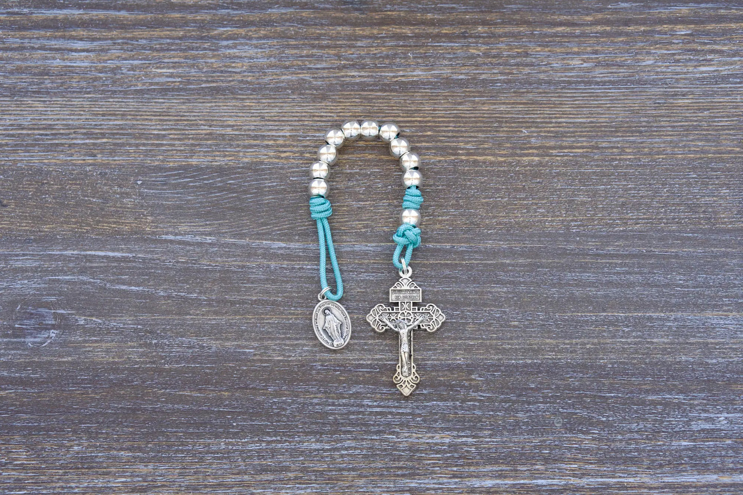 Divine Elegance premium metal paracord rosary with silver beads, crucifix, and medal in four vibrant colors.