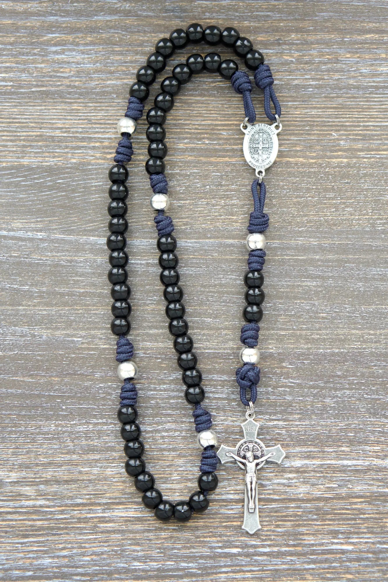 Black beaded metal paracord rosary with navy blue cord and silver crucifix.