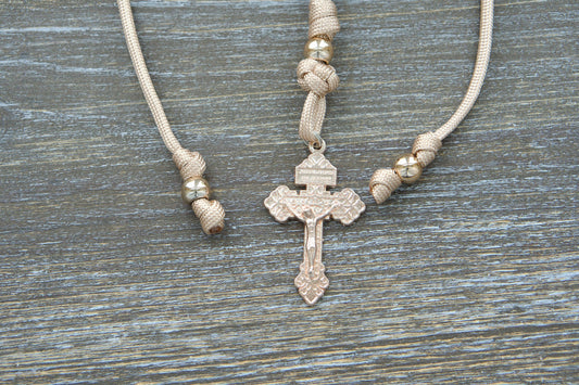 Handmade tan and rose gold paracord rearview mirror rosary with a unique rose gold Pardon crucifix centerpiece.