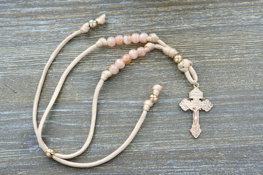 Gate of Heaven Rearview Mirror Rosary: Handmade tan/rose gold paracord rosary with rose gold Our Father bead, milky pink Hail Mary beads, and a unique rose gold Pardon Crucifix centerpiece.
