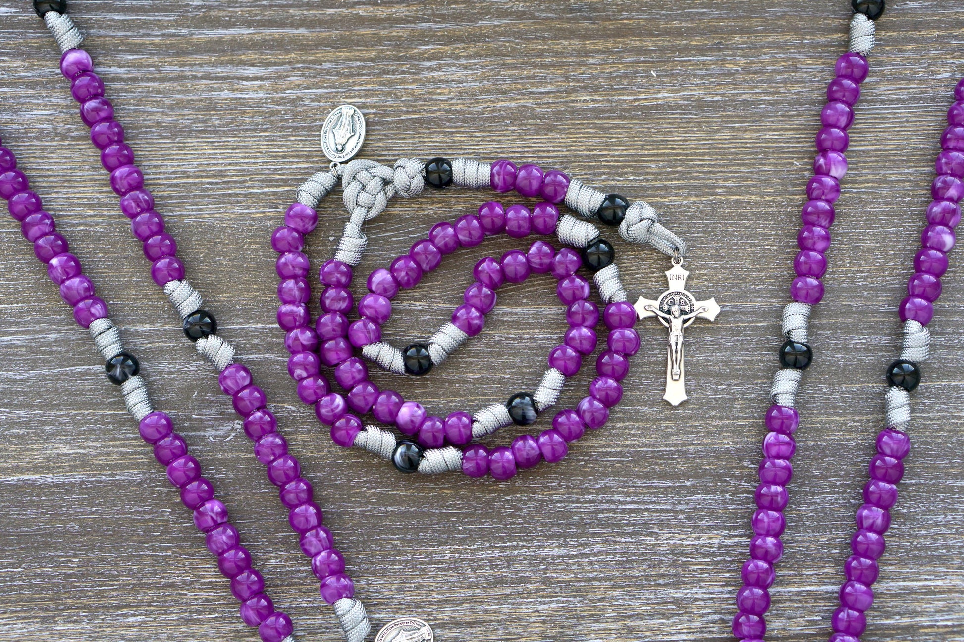 Gemstone Colored - 5 Decade Paracord Rosary with 2" St. Benedict Crucifix and Miraculous Medal Devotional Medal. Available in Garnet Red, Ingolite Blue, Emerald Green, and Magenta colors.