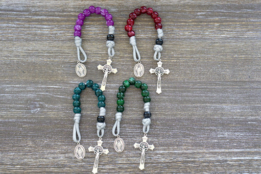 Gemstone Colored - 1 Decade Paracord Rosary, available in four beautiful colors - Garnet Red, Emerald Green, Ingolite Blue, and Magenta. Handcrafted with paracord 550, 12mm acrylic beads, Miraculous Medal devotional medal, and a 2-inch St. Benedict Crucifix for added spiritual strength.