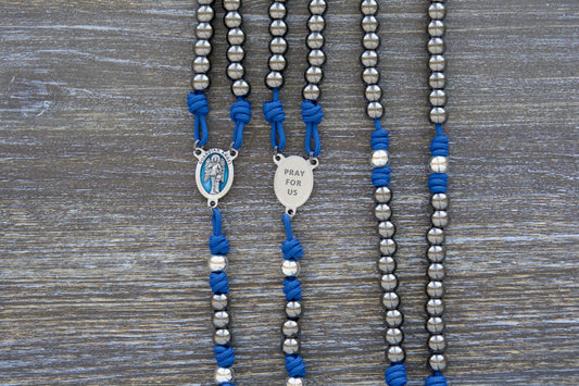 Guardian of Grace Premium Metal Paracord Rosary featuring royal blue paracord, gunmetal and silver metal alloy Hail Mary and Our Father beads, and a detailed blue enamel Guardian Angel centerpiece.
