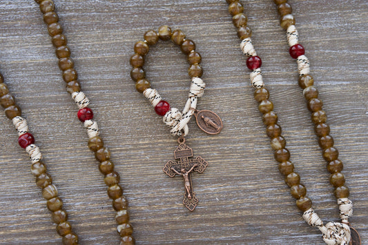 The Heavenly Rose Pocket Paracord Rosary: 12mm brown/mocha Hail Mary beads, maroon Our Father bead, tan paracord, copper crucifix & Miraculous Medal.