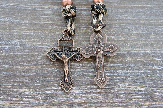 Heavy Duty Hail Mary rearview mirror rosary with camo black paracord, matte black beads, antique copper Our Father beads, and a copper Pardon crucifix.
