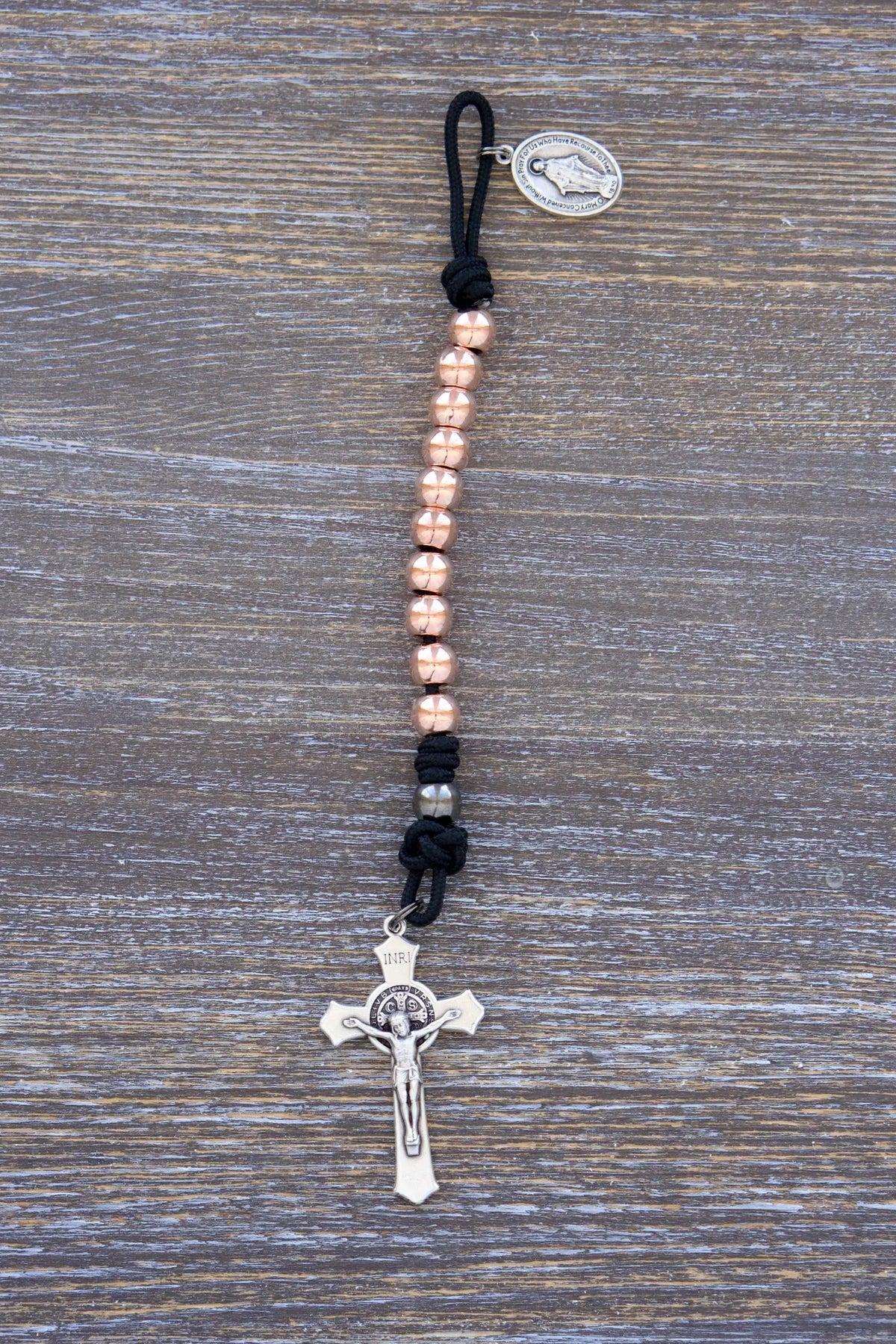 Immaculate Strength premium metal paracord rosary with black rope and rose gold beads, designed for strength and faith.