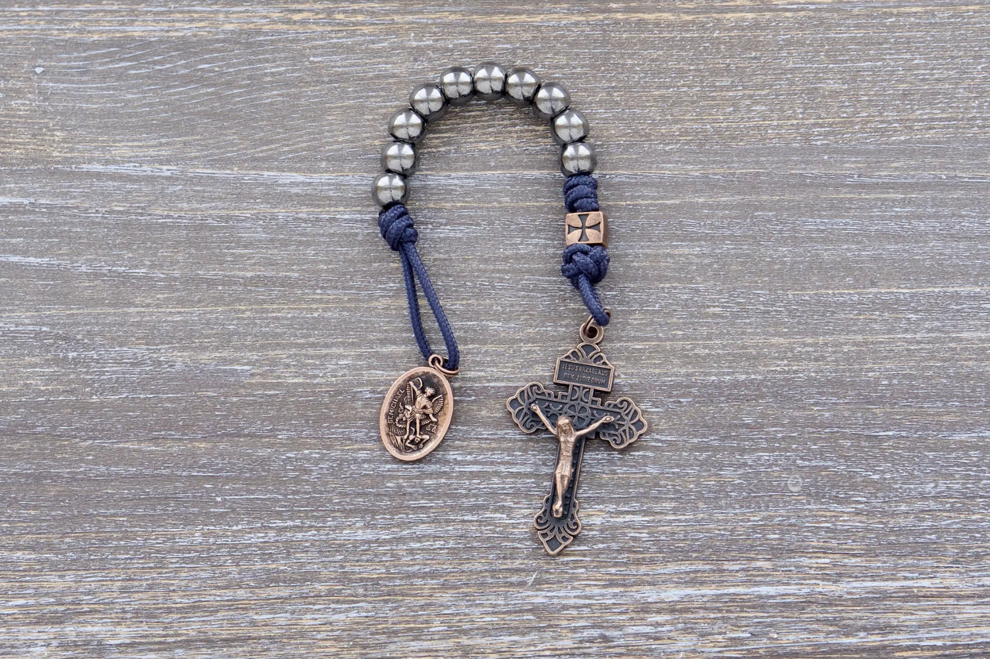 Iron Legion Premium Metal Pocket Paracord Rosary with copper crucifix and medal in navy or black rope.
