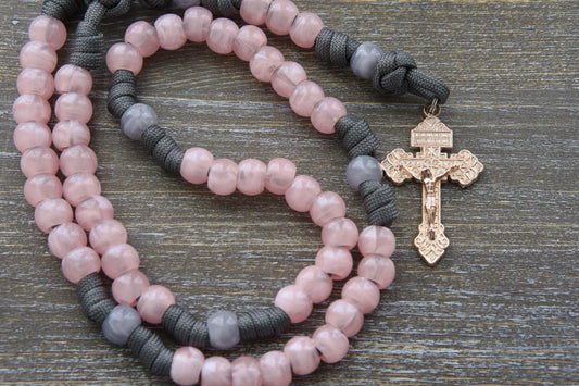 "Ite Ad Joseph" 5 Decade Paracord Rosary: A handcrafted, full-sized rosary featuring grey and milky pink paracord interwoven with acrylic Our Father and Hail Mary beads.
