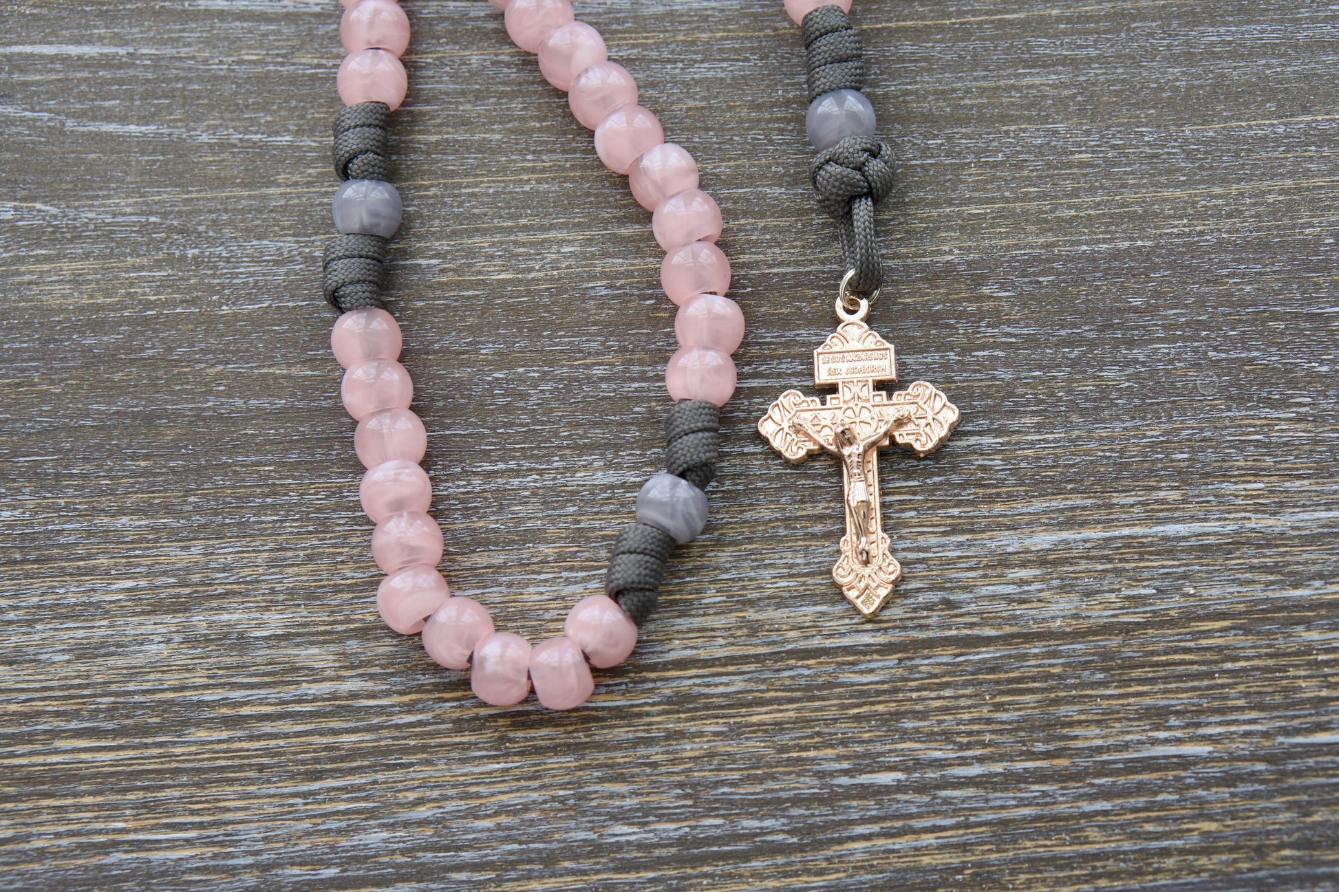 Handcrafted "Ite Ad Joseph" 5-Decade Rosary featuring grey and milky pink colors, 12mm acrylic beads, a St. Joseph medal, and a radiant rose gold Pardon crucifix.