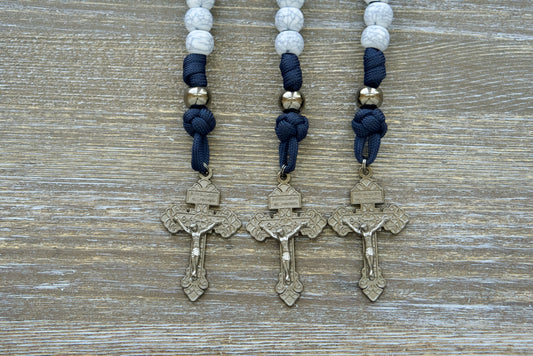 Marian Stronghold - Pocket Paracord Rosary, featuring premium quality materials and unbreakable strength in a durable design. This elegant rosary boasts 12mm beads, gunmetal Our Father beads, cracked ivory Hail Mary beads, and a matching 2-inch pardon crucifix.