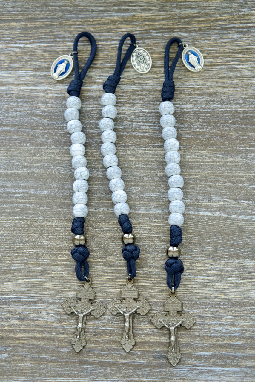 Marian Stronghold - Pocket Paracord Rosary with gunmetal Our Father beads, cracked ivory Hail Mary beads, blue enamel Miraculous Medal, and 2-inch Pardon Crucifix.