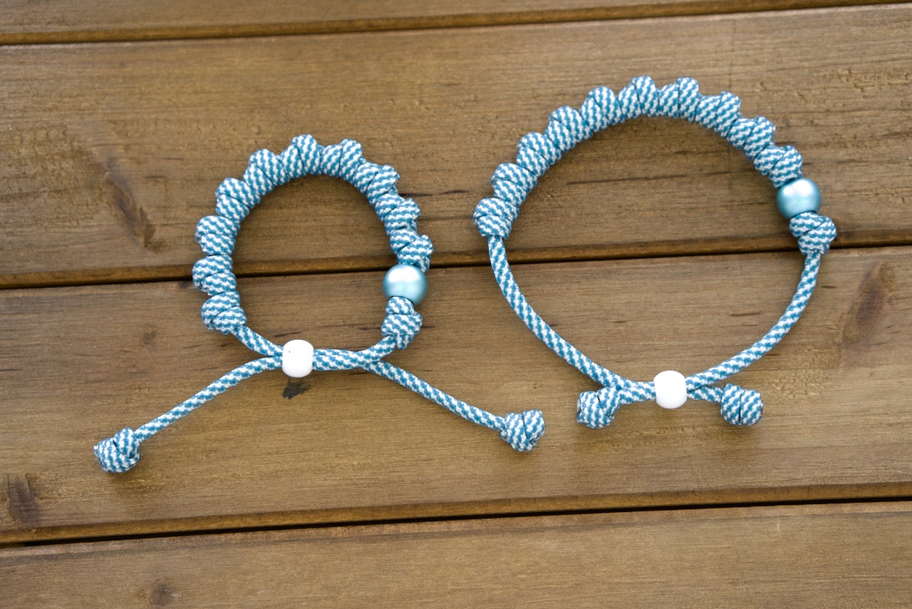 Discover the Mater Boni Consilii - Rosary Bracelet, our newest durable & premium paracord rosary. Stand out with its striking matte blue Our Father bead and vibrant blue & white paracord, representing Catholic traditions' strength and resilience.