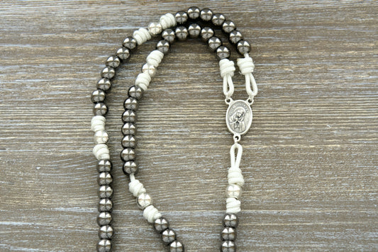 Beautiful white paracord 7 Sorrows Servite Rosary with silver and gunmetal beads, featuring the Mater Dolorosa/Ecce Homo centerpiece and a 2" Pardon Crucifix. Premium Catholic rosary chaplet for spiritual growth and contemplation.