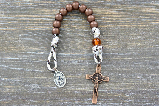 Antique copper Hail Mary beads, transparent copper Our Father bead, and St. Benedict crucifix on white paracord rosary.