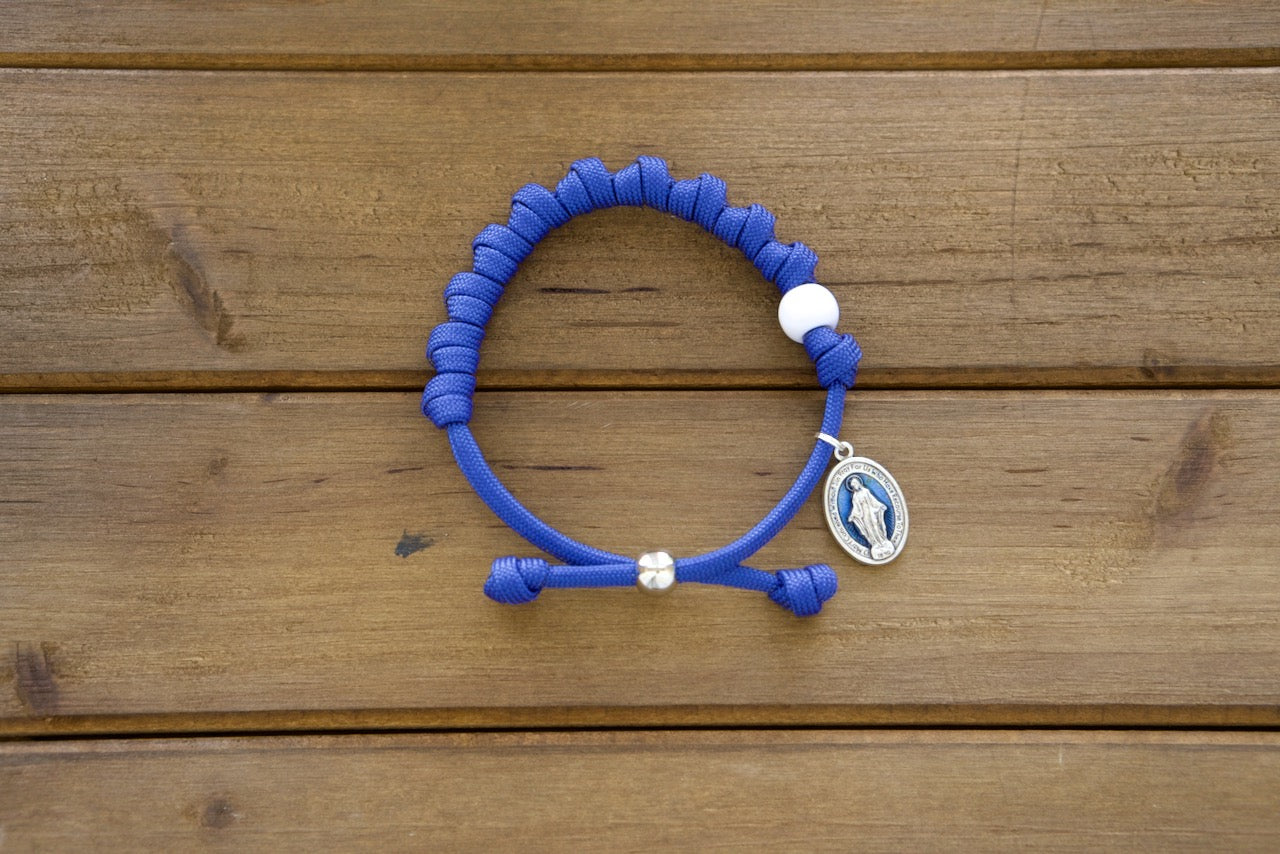 Our Lady of the Miraculous Medal - Unbreakable Rosary Bracelet, featuring a stunning blue enamel Miraculous medal on paracord with premium and durable craftsmanship for strong spiritual protection. Catholic gift perfect for prayer and faith strengthening.