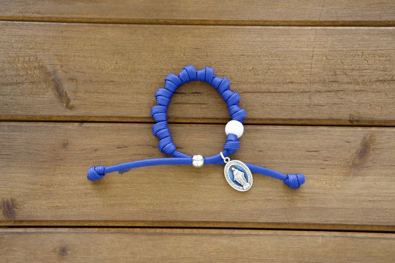 Unbreakable paracord rosary bracelet with a stunning blue enamel Miraculous medal, perfect for strengthening your faith through prayer and designed to withstand life's challenges.