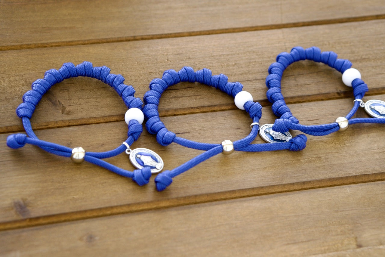 Our Lady of the Miraculous Medal - Unbreakable Rosary Bracelet, featuring a stunning blue enamel Miraculous medal on a durable paracord design. This premium Catholic gift is perfect for strengthening your faith through prayer and withstanding life's challenges.