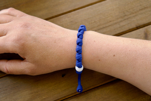 Our Lady of the Miraculous Medal - Unbreakable Paracord Rosary Bracelet. Handcrafted with premium materials including durable paracord and a stunning blue enamel Miraculous Medal, this Catholic gift is perfect for strengthening faith through prayer.