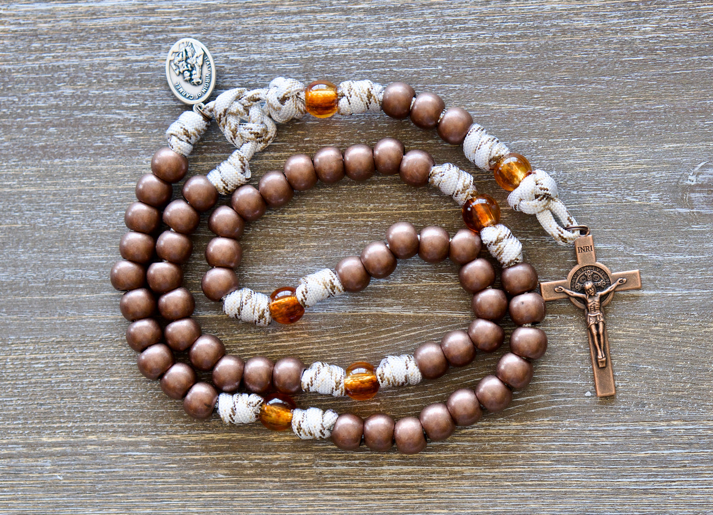 Our Lady of Mount Carmel 5 Decade Paracord Rosary featuring antique copper acrylic Hail Mary beads, transparent brown Our Father beads, copper St. Benedict crucifix, and paracord rope with copper-infused strands.