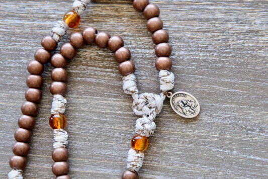 Our Lady of Mount Carmel - 5 Decade Paracord Rosary featuring antique copper Hail Mary beads, transparent brown Our Father beads, copper St. Benedict crucifix, and paracord rope with copper-infused strands.