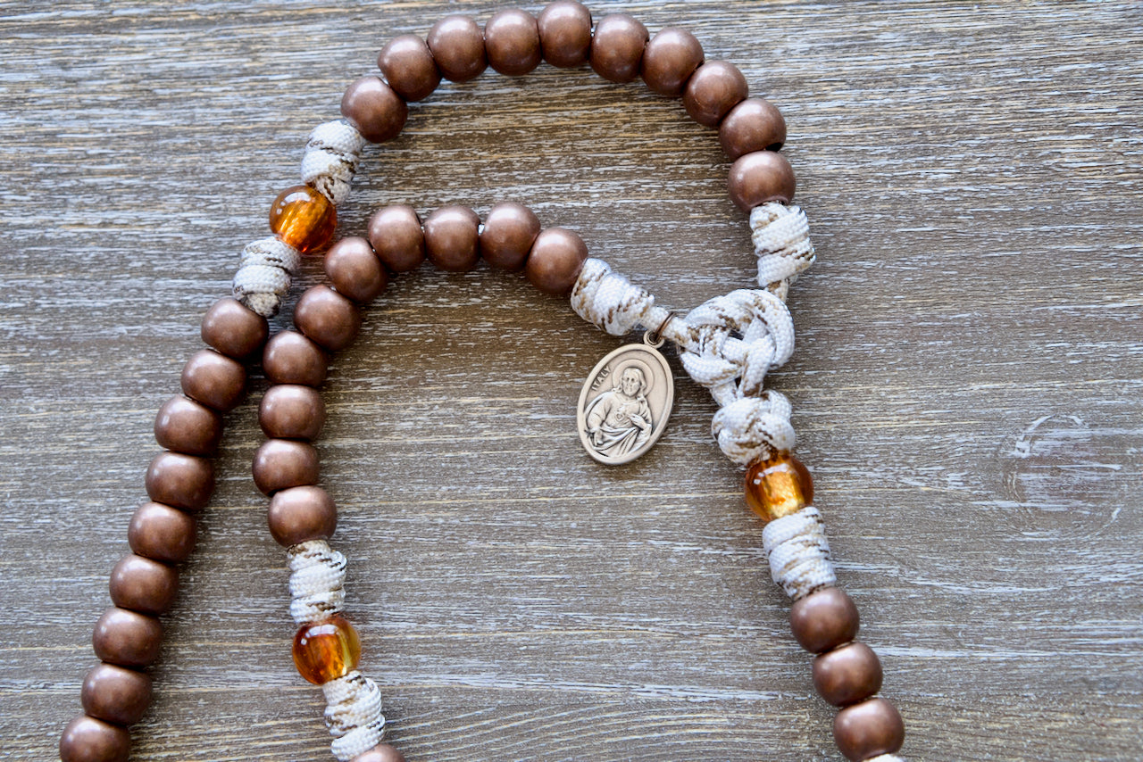 Our Lady of Mount Carmel 5 Decade Paracord Rosary featuring antique copper acrylic Hail Mary beads, transparent brown Our Father beads, copper St. Benedict crucifix and premium paracord rope with copper-infused strands.