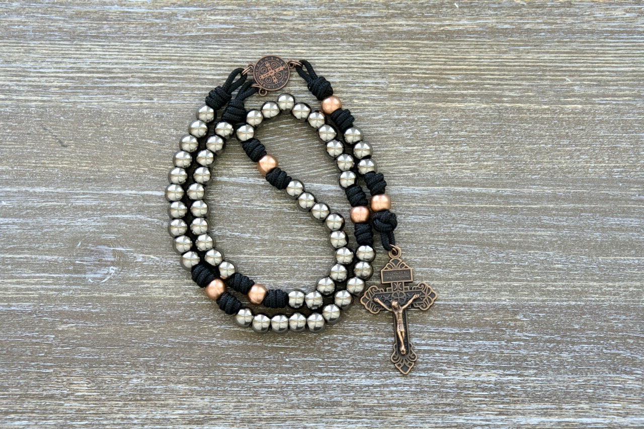 Path of the Disciple - Premium Metal Paracord Rosary featuring black paracord 275, elegant gunmetal Hail Mary beads, antique copper Our Father beads, and a stunning antique copper St. Benedict centerpiece; perfect for Catholics seeking strength in their devotional practices on the journey towards spiritual growth and closer intimacy with Jesus Christ.