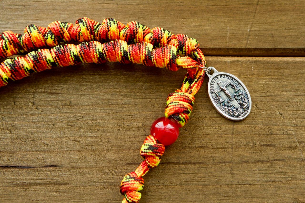 The Purgatory Releaser - Knotted Rope Rosary by Sanctus Servo, a premium unbreakable paracord rosary designed to withstand life's battles. This Catholic gift features the Holy Souls in Purgatory medal and comes handmade by our devout family for maximum spiritual effectiveness. Perfect for prayer warriors of all ages!