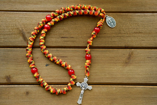 The Purgatory Releaser - Knotted Rope Rosary with St. Benedict Crucifix and Holy Souls in Purgatory Medal, featuring durable 550 Paracord rope construction and acrylic accent beads for a strong, unbreakable Catholic gift that fits perfectly in your hand or pocket for easy prayer on the go.