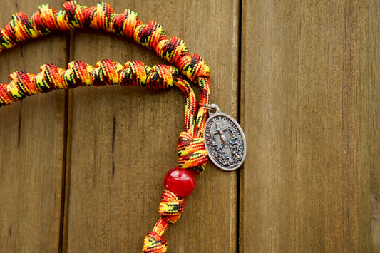 The Purgatory Releaser - Knotted Rope Rosary: A durable and powerful Catholic gift, designed to withstand life's battles. Handmade by our family of 6, this rosary features a Holy Souls in Purgatory medal and is rigorously tested for unbreakable strength. Perfect for prayer on-the-go!