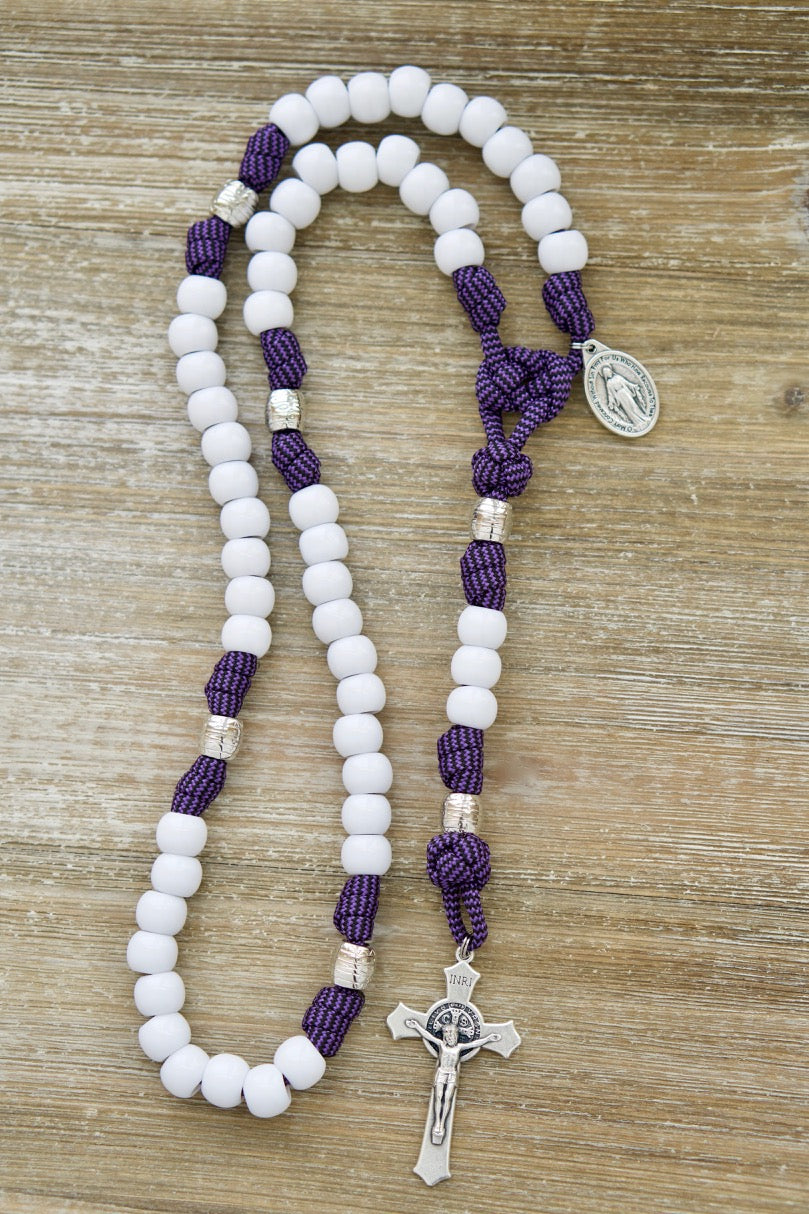 Experience the power of prayer with our Purple and White 5 Decade Paracord Rosary, designed for women who want a durable and unbreakable spiritual weapon! This premium Catholic gift features a stunning purple and white design, a 2" St. Benedict Crucifix, and the Miraculous Medal for devotion.