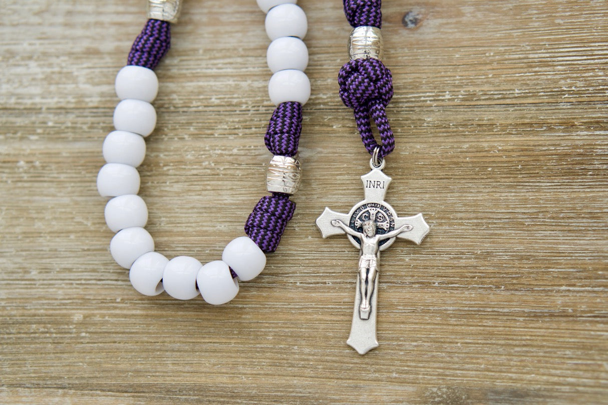 Unleash divine power with our durable Purple & White 5 Decade Paracord Rosary! This premium Catholic gift features a stunning design, 2" St. Benedict Crucifix, Miraculous Medal, and an overall length of 19 inches for easy handling.
