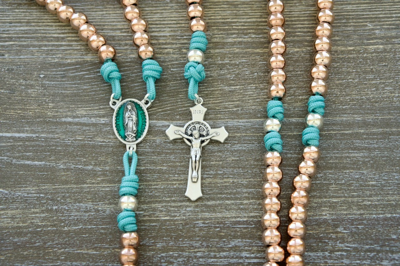 The Rosa Mystica | Our Lady of Guadalupe Premium Paracord Rosary - A beautiful and durable spiritual weapon for Catholic women, featuring teal blue paracord, metal alloy beads, an enamel Our Lady of Guadalupe centerpiece, and a silver Pardon Crucifix.