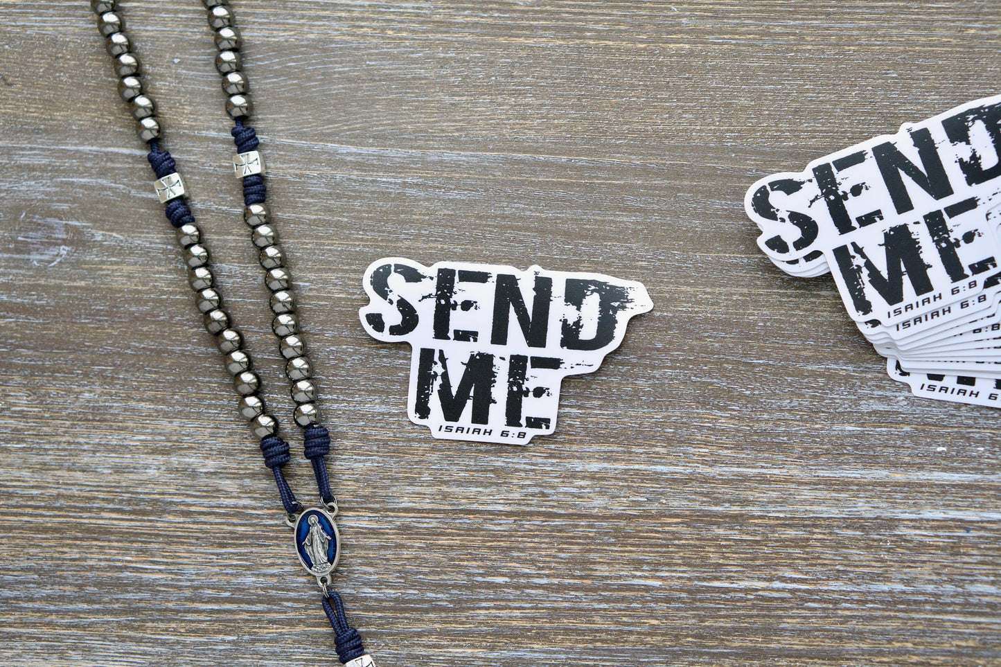 Motivational vinyl sticker featuring the quote 'Lo, here am I, SEND ME' from Isaiah 6:8, measuring 3.75"x2.34". Semi-gloss white vinyl with matte laminate for durability and a sleek finish. Suitable for indoor/outdoor use on various surfaces.