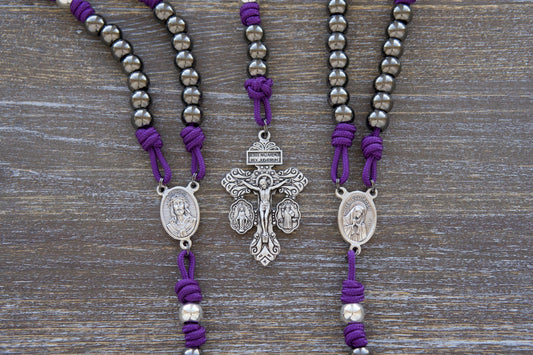 Sturdy purple paracord Servite Rosary chaplet featuring 10mm silver 'Our Father' beads, gunmetal 'Hail Mary' beads, and a centerpiece medal depicting Mater Dolorosa (Our Lady of Sorrows) on one side and Ecce Homo on the other.