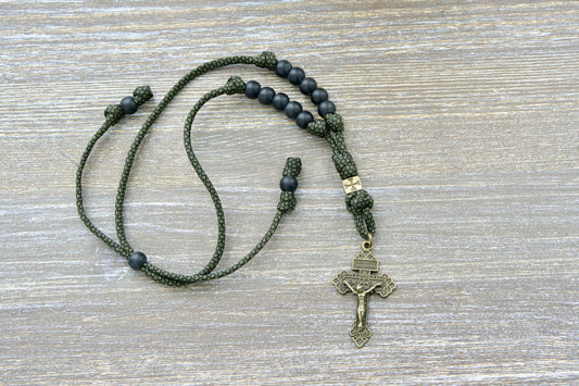 Durable green camo paracord rearview mirror rosary featuring matte black Hail Mary beads, olive Our Father bead, and olive Pardon crucifix.